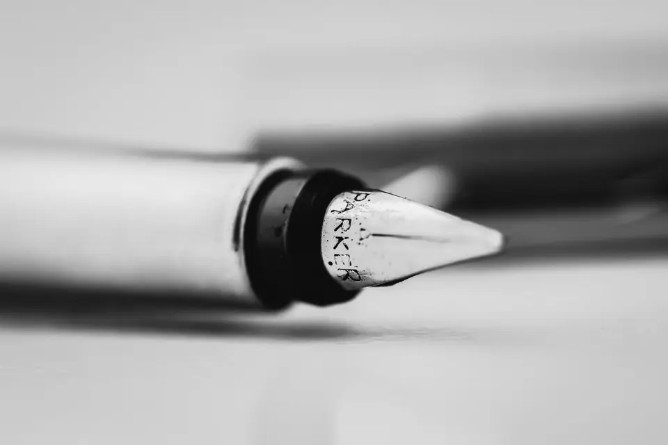 A close view of a fountain pen’s metal nib, with the word “Parker” engraved on it.