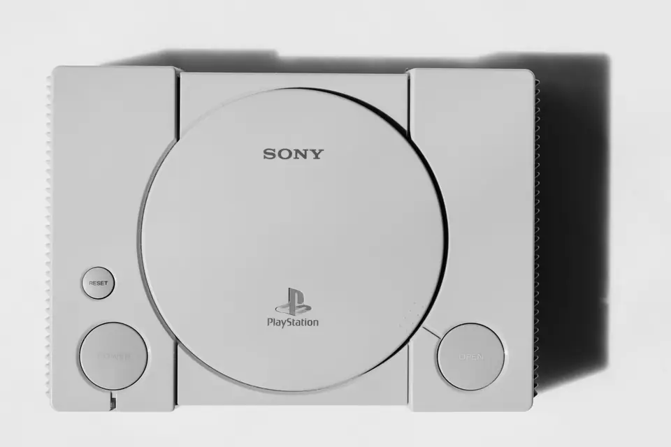 A top view of a gray game console with a round disc lid marked “Sony” and “PlayStation.”